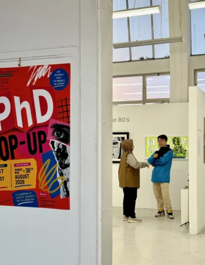 Visitors at the PhD pop-up exhibition in a white gallery